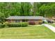 Beautiful brick home with a lush green lawn, mature trees, and a covered carport for convenience at 3050 Rebecca Sw Dr, Atlanta, GA 30311