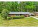 Well-maintained brick home with green shutters, mature trees, and a long driveway; ready for new owners at 3050 Rebecca Sw Dr, Atlanta, GA 30311