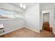 Bright kitchen area featuring white walls, two windows, neutral vinyl flooring, and a small table area at 3050 Rebecca Sw Dr, Atlanta, GA 30311