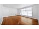 Spacious living room featuring hardwood floors and a large window for natural light at 3050 Rebecca Sw Dr, Atlanta, GA 30311