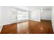 Open living area with hardwood floors and a door with access to the backyard at 3050 Rebecca Sw Dr, Atlanta, GA 30311