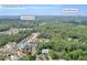 A home is surrounded by lush greenery with Stone Mountain in the distance at 3178 Arbor Oaks Way, Snellville, GA 30039