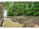 Beautiful backyard features a green lawn, mature trees, and a patio space at 3178 Arbor Oaks Way, Snellville, GA 30039