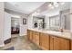 Bright bathroom with double sinks, a large mirror, and a view into the bedroom at 3178 Arbor Oaks Way, Snellville, GA 30039