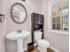 Half bath with pedestal sink and natural lighting at 3178 Arbor Oaks Way, Snellville, GA 30039