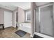 Modern bathroom featuring a soaking tub, a glass-enclosed shower, and a toilet at 3178 Arbor Oaks Way, Snellville, GA 30039