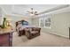 Spacious bedroom with a tray ceiling, ceiling fan, and a cozy sitting area at 3178 Arbor Oaks Way, Snellville, GA 30039
