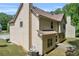 Back exterior of the home featuring vinyl siding, roof, and well-kept lawn at 3178 Arbor Oaks Way, Snellville, GA 30039