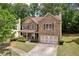 Charming two-story home with stone accents, a two-car garage, and a well-maintained front yard at 3178 Arbor Oaks Way, Snellville, GA 30039