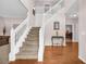 Spacious foyer with hardwood floors, a staircase, and elegant decor at 3178 Arbor Oaks Way, Snellville, GA 30039