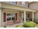 Inviting front porch with stone accents, seating, and manicured landscaping at 3178 Arbor Oaks Way, Snellville, GA 30039