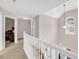 Upstairs hallway featuring white staircase and chandelier at 3178 Arbor Oaks Way, Snellville, GA 30039