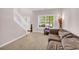 Comfortable living room with a staircase, large window, and a view to the exterior at 3178 Arbor Oaks Way, Snellville, GA 30039