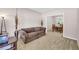 Cozy living room with plush seating, neutral tones, and a view into the dining area at 3178 Arbor Oaks Way, Snellville, GA 30039