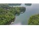 A lushly wooded lot with lake access and private dock at 7830 Kings Point Dr, Cumming, GA 30041