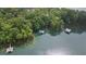 Picturesque aerial shot featuring private docks and serene lake waters surrounded by greenery at 7830 Kings Point Dr, Cumming, GA 30041