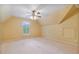 Bedroom with carpet, ceiling fan and a window with shutter overlooking a wooded area at 7830 Kings Point Dr, Cumming, GA 30041