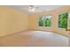 Bedroom with neutral carpet, and two windows overlooking a beautiful wooded area at 7830 Kings Point Dr, Cumming, GA 30041