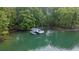 Scenic lake view of a private boat dock featuring a covered boat slip and clear water at 7830 Kings Point Dr, Cumming, GA 30041
