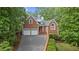 Charming brick home with a two-car garage and well-manicured landscaping at 7830 Kings Point Dr, Cumming, GA 30041