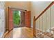 Bright foyer with hardwood floors, staircase, and a view of the exterior at 7830 Kings Point Dr, Cumming, GA 30041