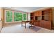 Bright home office with large windows, built-in shelving, and a desk area at 7830 Kings Point Dr, Cumming, GA 30041