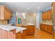 Spacious kitchen featuring custom cabinetry, hardwood floors, and a functional center island at 7830 Kings Point Dr, Cumming, GA 30041