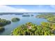 Breathtaking aerial perspective of waterfront property surrounded by the clear waters at 7830 Kings Point Dr, Cumming, GA 30041
