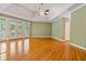 Bright living room features hardwood floors, tray ceiling, french doors and neutral paint at 7830 Kings Point Dr, Cumming, GA 30041