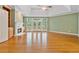 Light-filled living room featuring a fireplace, built-in cabinets, and french doors to the back deck at 7830 Kings Point Dr, Cumming, GA 30041