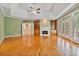 Living room with hardwood floors, a fireplace, and built-in bookshelves at 7830 Kings Point Dr, Cumming, GA 30041