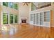 Spacious living room with hardwood floors, fireplace, built-in bookcases and natural light at 7830 Kings Point Dr, Cumming, GA 30041