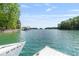 Picturesque waterfront view with a private dock and boat access to the open water at 7830 Kings Point Dr, Cumming, GA 30041