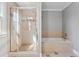 Well-appointed bathroom featuring a separate shower and soaking tub, perfect for relaxation at 1236 Brickton Nw Dr, Atlanta, GA 30318