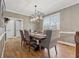Elegant dining room with hardwood floors, modern lighting, and a large window with outside views at 1236 Brickton Nw Dr, Atlanta, GA 30318