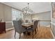Open dining area with hardwood floors, stylish lighting, and easy access to the staircase at 1236 Brickton Nw Dr, Atlanta, GA 30318