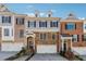 Charming townhome showcasing brick and stone accents, complemented by a well-manicured lawn at 1236 Brickton Nw Dr, Atlanta, GA 30318