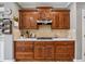 Warm kitchen featuring wooden cabinets, stainless steel appliances, and tiled backsplash at 1236 Brickton Nw Dr, Atlanta, GA 30318
