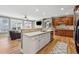 Spacious kitchen features white cabinets, stainless appliances, opens to living room with fireplace and TV at 1236 Brickton Nw Dr, Atlanta, GA 30318