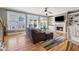 Inviting living room with large windows, hardwood floors, built-in bookshelves, and a cozy fireplace at 1236 Brickton Nw Dr, Atlanta, GA 30318