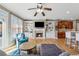Bright living room with fireplace, built-in shelving, hardwood flooring, and open access to kitchen at 1236 Brickton Nw Dr, Atlanta, GA 30318