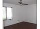Clean and bright bedroom with a modern ceiling fan, window and hardwood flooring at 1457 Stoneleigh Cir, Stone Mountain, GA 30088