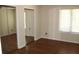 Bright bedroom featuring wood floors and large windows with mirrored closet doors at 1457 Stoneleigh Cir, Stone Mountain, GA 30088