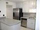 Bright kitchen with stainless steel appliances, white cabinets, and a convenient breakfast bar at 1457 Stoneleigh Cir, Stone Mountain, GA 30088
