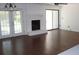 Spacious living room with fireplace, hardwood floors, neutral paint, and a sliding glass door at 1457 Stoneleigh Cir, Stone Mountain, GA 30088