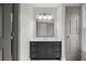 Bathroom featuring a modern vanity with dark gray cabinetry and a large, well-lit mirror at 1827 Shaker Falls Ln, Lawrenceville, GA 30045