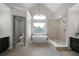 Luxurious bathroom featuring a standalone tub, walk-in shower, and modern fixtures at 1827 Shaker Falls Ln, Lawrenceville, GA 30045