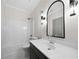 Bathroom featuring modern vanity and tub with shower at 1827 Shaker Falls Ln, Lawrenceville, GA 30045