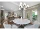 Open floor plan with a view of the backyard and stylish light fixture at 1827 Shaker Falls Ln, Lawrenceville, GA 30045