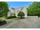 Stately home featuring a manicured lawn, columns, and a circular driveway at 1827 Shaker Falls Ln, Lawrenceville, GA 30045